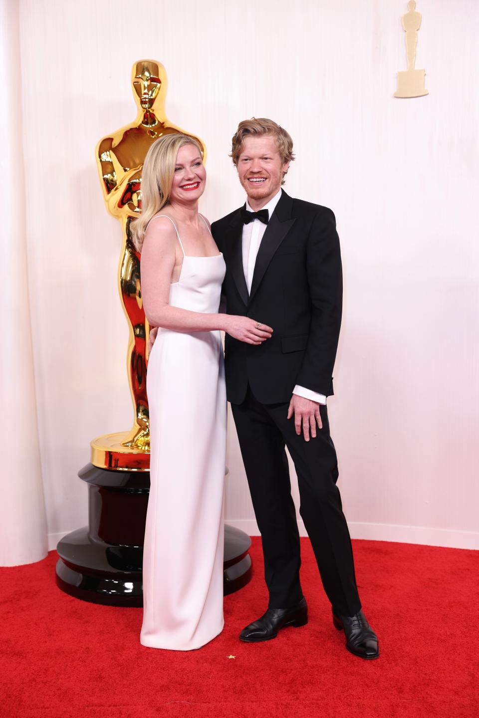Image may contain: Jesse Plemons, Kirsten Dunst, Fashion, Accessories, Formal Wear, Tie, Clothing, Footwear, Shoe, and Adult