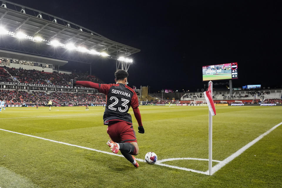 Toronto FC midfielder Brandon Servania (23) takes a corner kick against Charlotte FC during the first half of an MLS soccer match Saturday, April 1, 2023, in Vancouver, British Columbia. (Andrew Lahodynskyj/The Canadian Press via AP)