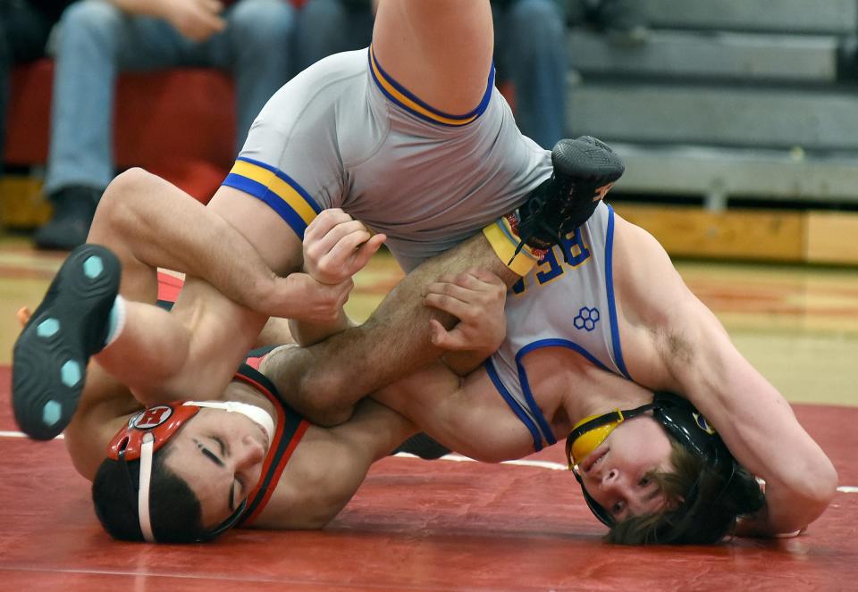 Braydon Hall of New Boston Huron (left) and Jefferson's Ryder Mulherin battle for control. Hall won the 138 pounds match 3-2 on Wednesday, Jan. 24, 2024. Jefferson dominated the battle of the last two unbeaten teams in the Huron League 55-12.