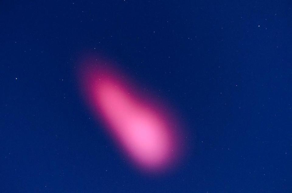 A pink astral cloud appeared in the sky of Tucson, Arizona, after a NASA rocket launch from White Sands, New Mexico in this handout photo taken the morning of February 25, 2015, provided by White Sands Missile Range. An unusual pink cloud that lit up the sky over New Mexico and Arizona early on Wednesday was caused by a NASA research rocket launched to study the outer reaches of Earth's atmosphere, scientists said. REUTERS/White Sands Missile Range/Handout (UNITED STATES - Tags: ENVIRONMENT SCIENCE TECHNOLOGY) FOR EDITORIAL USE ONLY. NOT FOR SALE FOR MARKETING OR ADVERTISING CAMPAIGNS. THIS IMAGE HAS BEEN SUPPLIED BY A THIRD PARTY. IT IS DISTRIBUTED, EXACTLY AS RECEIVED BY REUTERS, AS A SERVICE TO CLIENTS