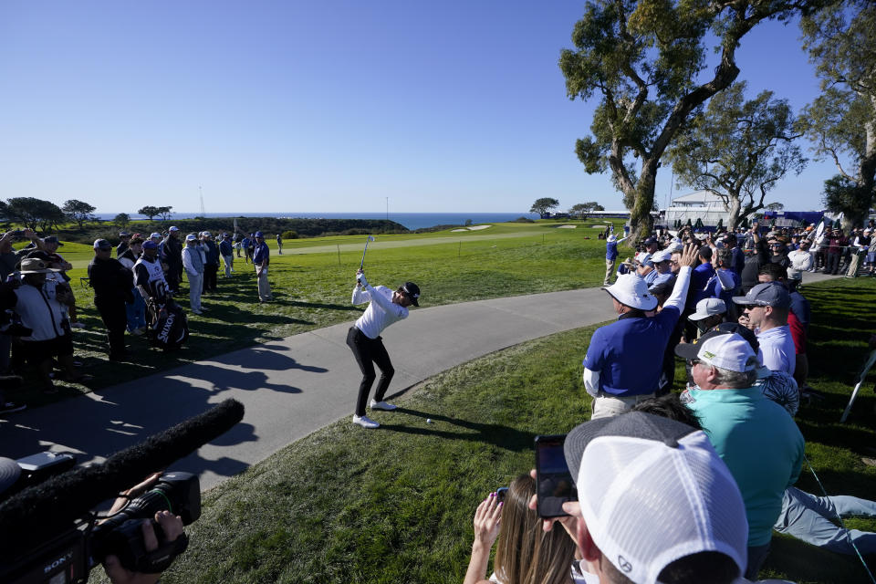 Sam Ryder, center, hits alongside the path while playing the 14th hole of the South Course at Torrey Pines during the second round of the Farmers Insurance Open golf tournament, Thursday, Jan. 26, 2023, in San Diego. (AP Photo/Gregory Bull)