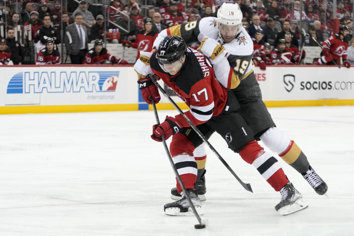New Jersey Devils center Yegor Sharangovich (17) skates against Vegas Golden Knights right wing Reilly Smith (19) during the second period of an NHL hockey game, Tuesday, Jan. 24, 2023, in Newark, N.J. (AP Photo/Mary Altaffer)