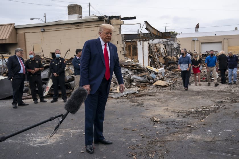 President Donald Trump tours an area on Tuesday, Sept. 1, 2020, damaged during demonstrations after a police officer shot Jacob Blake in Kenosha, Wis. (AP Photo/Evan Vucci)