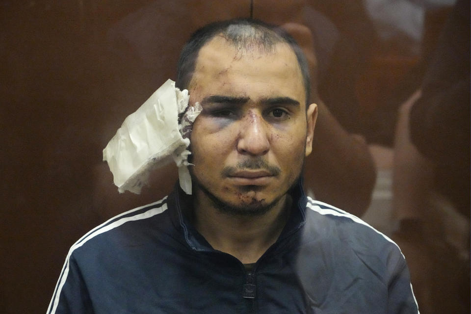 Saidakrami Murodali Rachabalizoda, a suspect in the Crocus City Hall shooting on Friday, sits in a glass cage in the Basmanny District Court in Moscow, Russia, Sunday, March 24, 2024. The four men charged with the massacre at a Moscow theater have been identified by the Russian government as citizens of Tajikistan, some of the thousands who migrate each year from the poorest of the former Soviet republics to scrape out marginal existences. (AP Photo/Alexander Zemlianichenko)