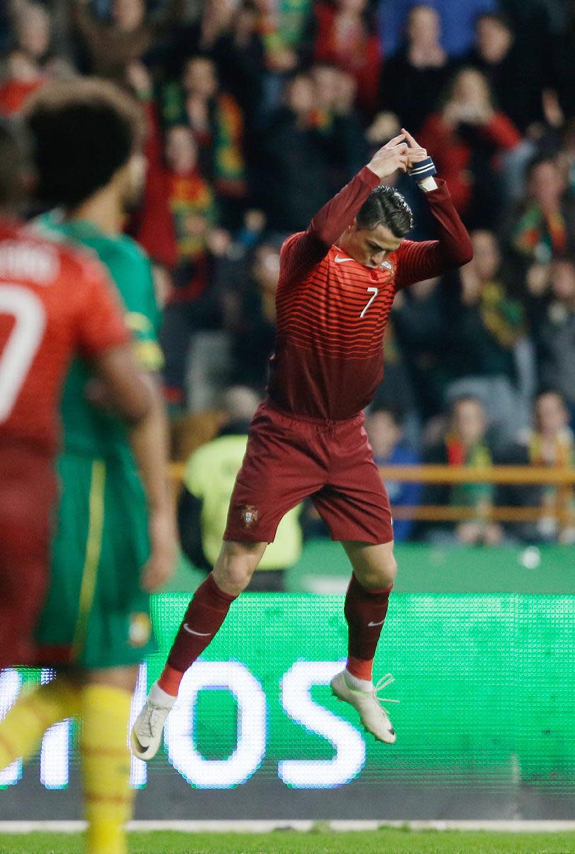 Portugal's Cristiano Ronaldo celebrates after scoring the opening goal during their friendly soccer match with Cameroon Wednesday, March 5 2014, in Leiria, Portugal. The game is part of both teams' preparation for the World Cup in Brazil. (AP Photo/Armando Franca)