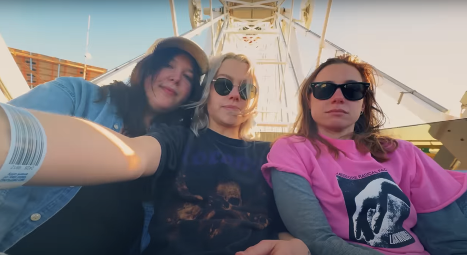 Lucy Dacus, Phoebe Bridgers, and Julien Baker taking a selfie on a roller coaster