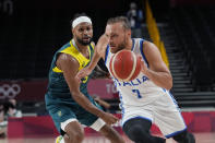 Italy's Stefano Tonut (7) drives around Australia's Patty Mills (5) during a men's basketball preliminary round game at the 2020 Summer Olympics, Wednesday, July 28, 2021, in Saitama, Japan. (AP Photo/Eric Gay)