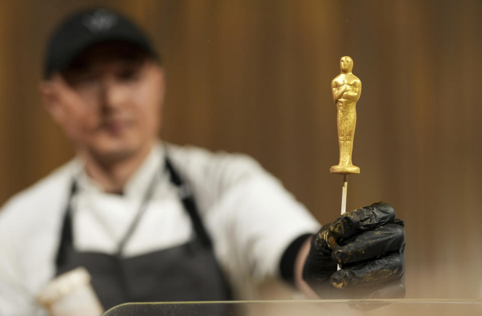 Junghoon Pak presents a chocolate statue during the Governors Ball press preview for the 96th Academy Awards, Tuesday, March 5, 2024, in Los Angeles. The Academy Awards will be held on Sunday, March 10. (Photo by Jordan Strauss/Invision/AP)