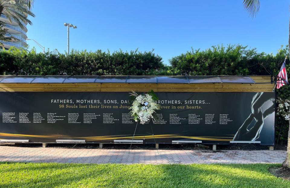 A memorial displays the name of people who died in the Surfside condo collapse.