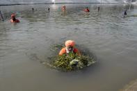 <p>Balbir Singh Seechewal (C) and his Sikh followers clean up the Kali Bein canal in Kapurthala on June 4, 2016. Singh is popularly known as the “eco-baba” in India due to various efforts to conserve the environment. </p>