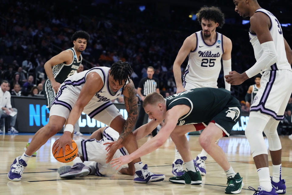 Kansas State forward Keyontae Johnson, left, and Michigan State forward Joey Hauser (10) reach for the loose ball in the second half of a Sweet 16 college basketball game in the East Regional of the NCAA tournament at Madison Square Garden, Thursday, March 23, 2023, in New York. (AP Photo/Frank Franklin II)