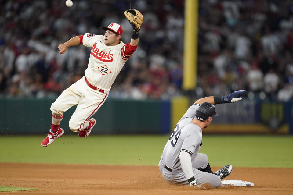 New York Yankees' Aaron Judge (99) steals second base ahead of a throw to Los Angeles Angels shortstop David Fletcher (22) during the ninth inning of a baseball game in Anaheim, Calif., Wednesday, Aug. 31, 2022. (AP Photo/Ashley Landis)