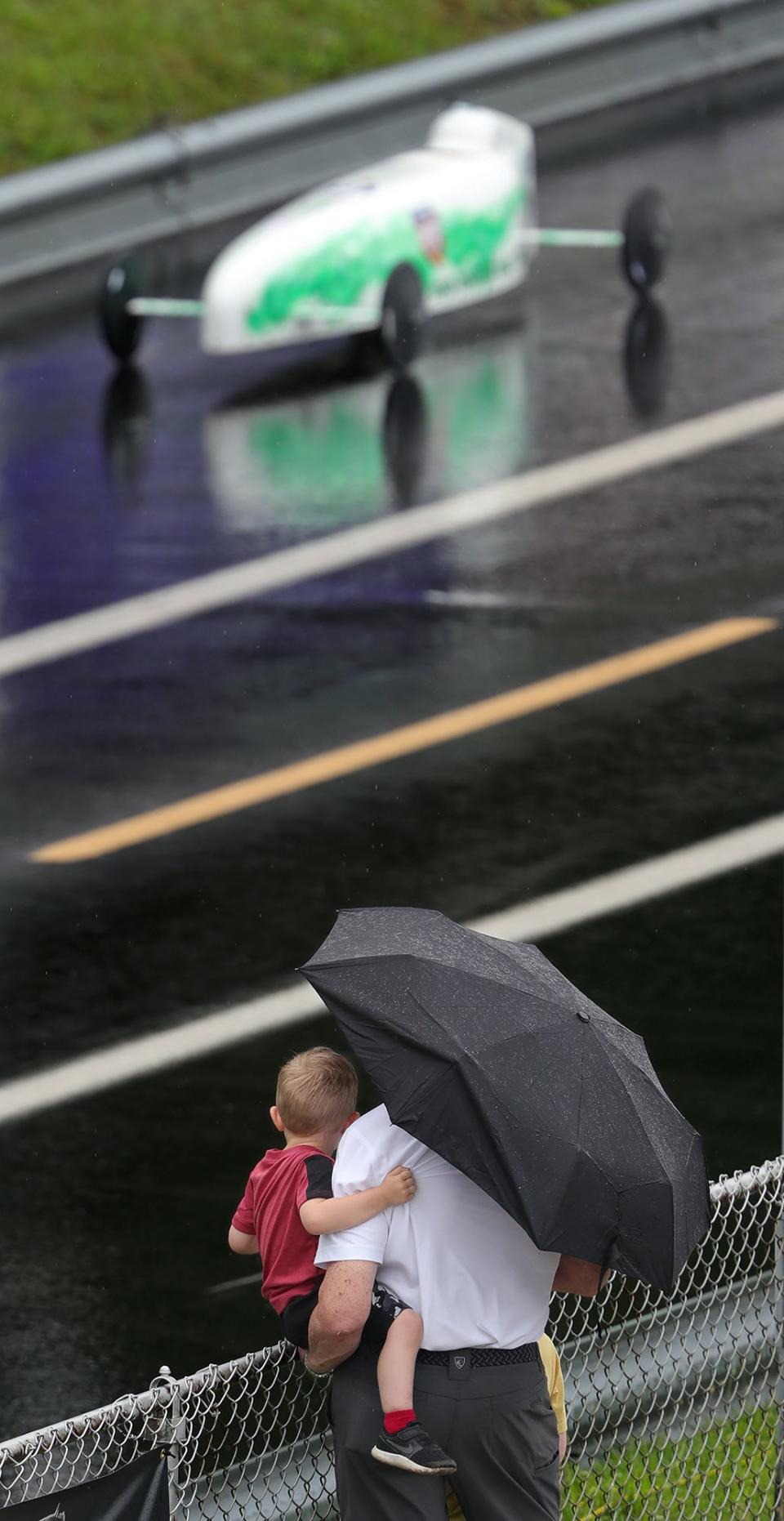 A young race fan watches the race with his guardian at Derby Downs.