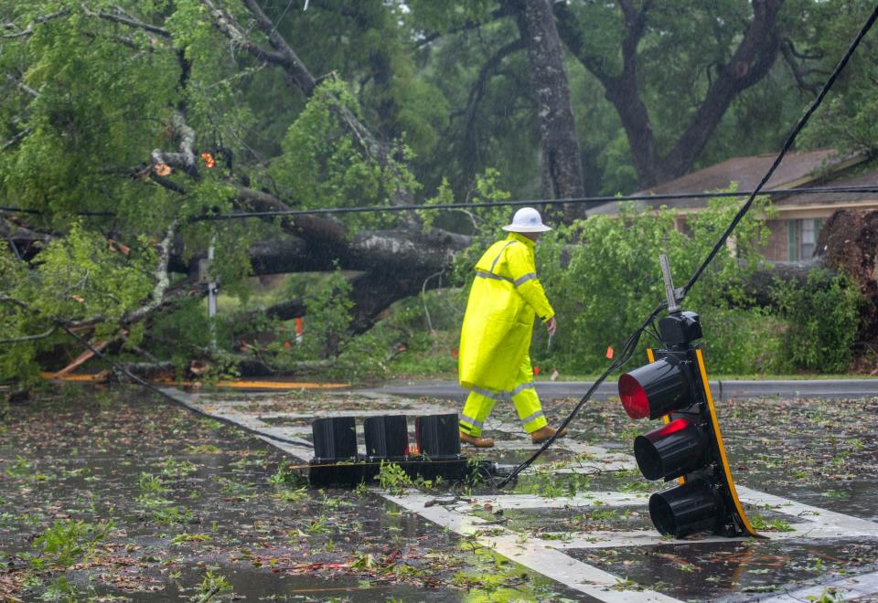 Traffic lights, utility lines and debris cover the street at the intersection of Longleaf and Community Drives as a storm passes through the Pensacola area on Wednesday, April 10, 2024.