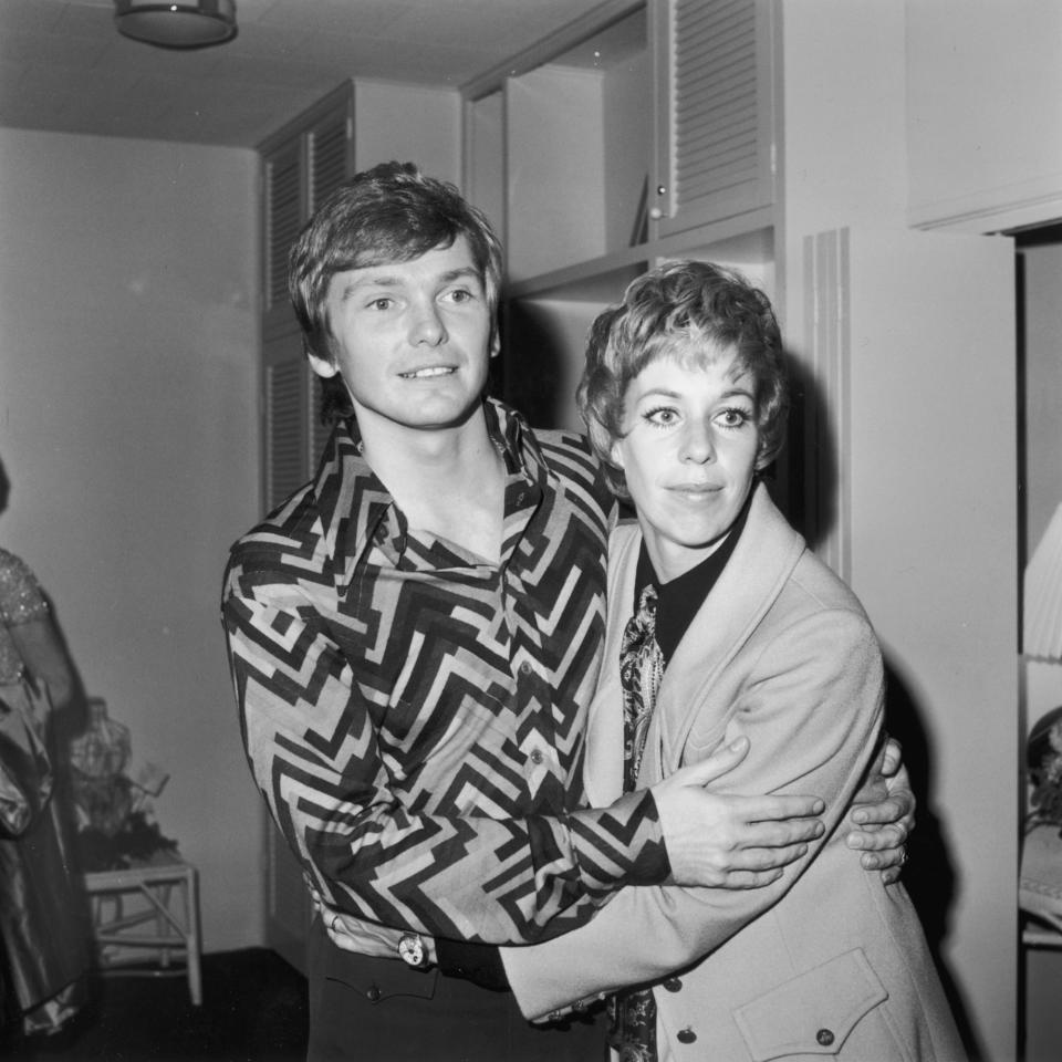 American fashion designer Bob Mackie embraces actor and comedian Carol Burnett at one of his fashion shows. 