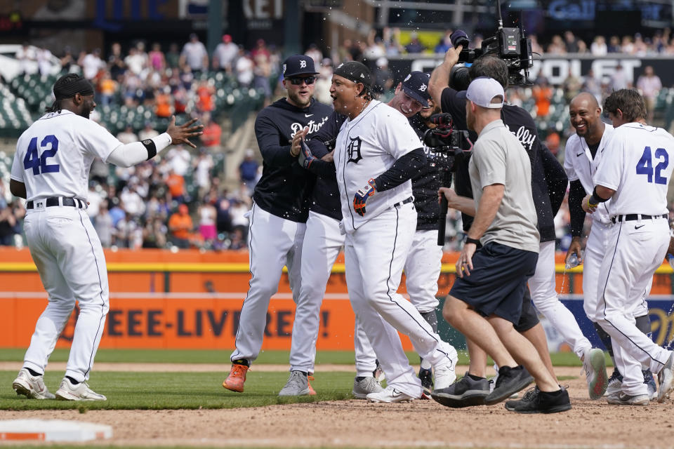 Teammates surround Detroit Tigers designated hitter Miguel Cabrera, center, after his walk-off single during the 11th inning of a baseball game against the San Francisco Giants, Saturday, April 15, 2023, in Detroit. (AP Photo/Carlos Osorio)