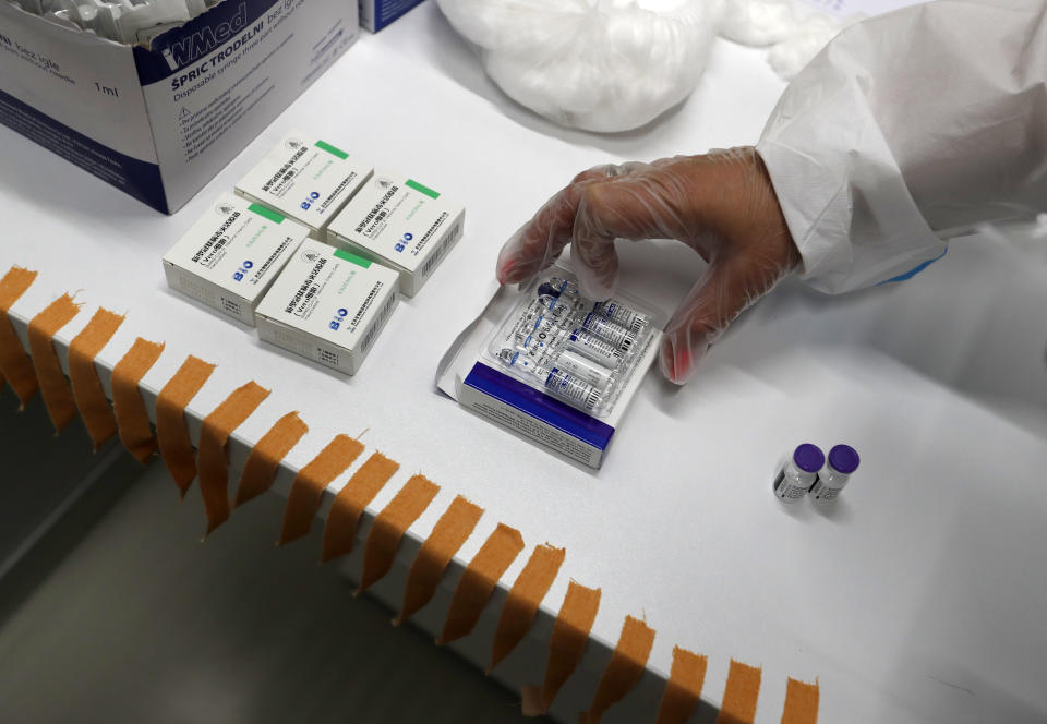 A medical worker prepares vials of the COVID-19 vaccines, Chinese Sinopharm, left, Sputnik V, center, and Pfizer at a vaccine centre, in the Usce shopping mall in Belgrade, Serbia, Thursday, May 6, 2021. Serbian authorities are looking for incentives for people to boost vaccination that has slowed down in recent weeks amid widespread anti-vaccination and conspiracy theories in the Balkan nation. The government has also promised a payment of around 25 euros to everyone who gets vaccinated by the end of May. (AP Photo/Darko Vojinovic)