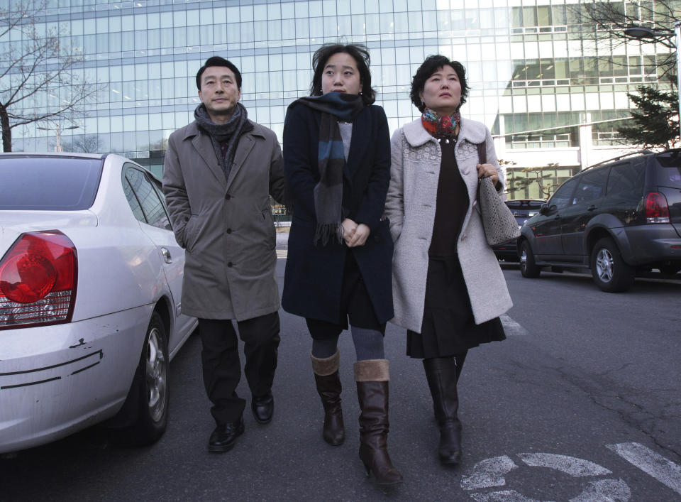 In this Friday, Jan. 9. 2014 photo, parents Jeon Jang-Beom and Yoon Hyun-Jin with their daughter Jeon Ji-Hye, center, leave Seoul High Court after attending their son Jeon Seong-Jin's trial, in Seoul. Jeon Seong-Jin, a 26-year-old dentist, is being punished for a crime that is not a crime at all in most of the world. A Jehovah’s Witness, he has refused to become a soldier in South Korea, where all able-bodied male citizens are required to serve about 21 months in the army. More than 660 conscientious objectors were jailed each year in South Korea from 2004 to 2012, far more than any other country. Eritrea comes in second with only about 50 imprisoned, according to the official website of Jehovah’s Witnesses, who often refuse military service because they believe the Bible forbids warfare. (AP Photo/Ahn Young-joon)