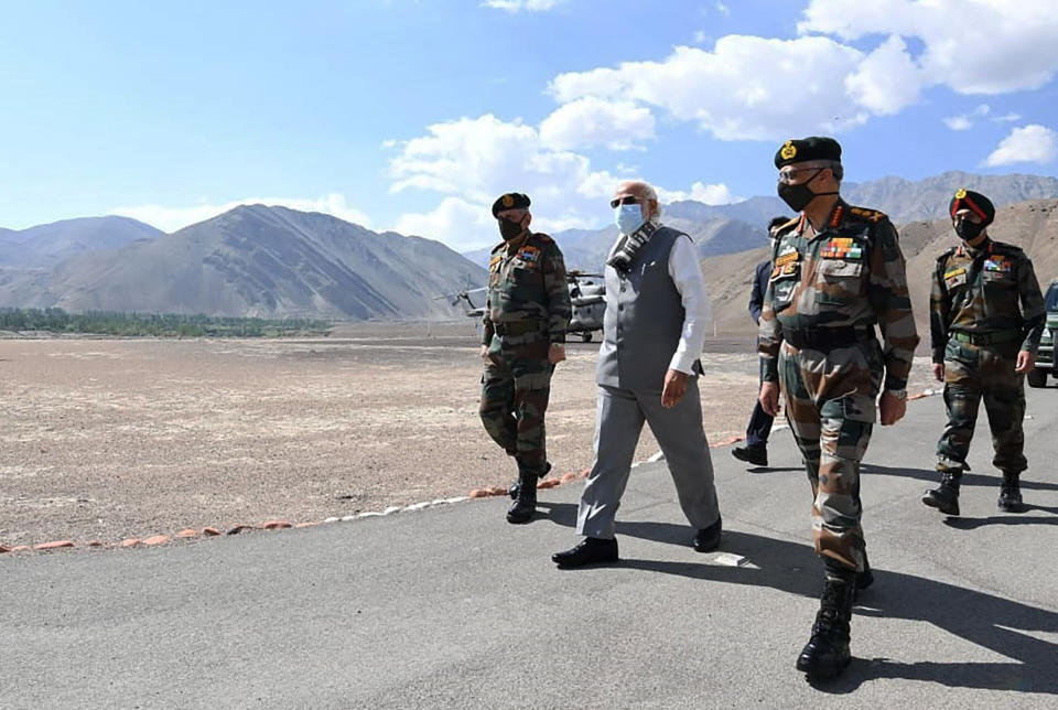 In this handout photo provided by the Press Information Bureau, Indian Prime Minister Narendra Modi walks with soldiers during a visit to the Ladakh area, India, Friday, July 3, 2020. Modi made an unannounced visit Friday to a military base in remote Ladakh region bordering China where the soldiers of the two countries have been facing off for nearly two months. Modi’s visit comes in the backdrop of massive Indian army build-up in Ladakh region following hand-to-hand combat between Indian and Chinese soldiers on June 15 that left 20 Indian soldiers dead and dozens injured, the worst military confrontation in over four decades between the Asian giants. (Press Information Bureau via AP)
