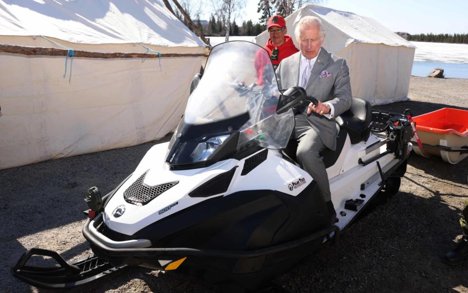 The Prince of Wales tried out a snowmobile when he met the Canadian Rangers on Thursday - GETTY IMAGES