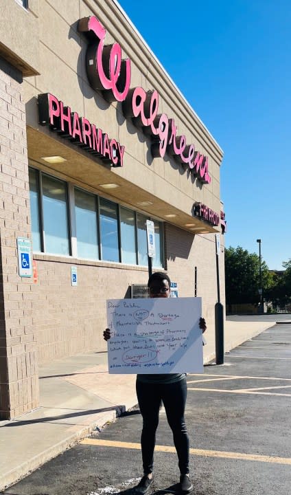 Dr. Bled Tanoe protesting outside of an Oklahoma City Walgreens.