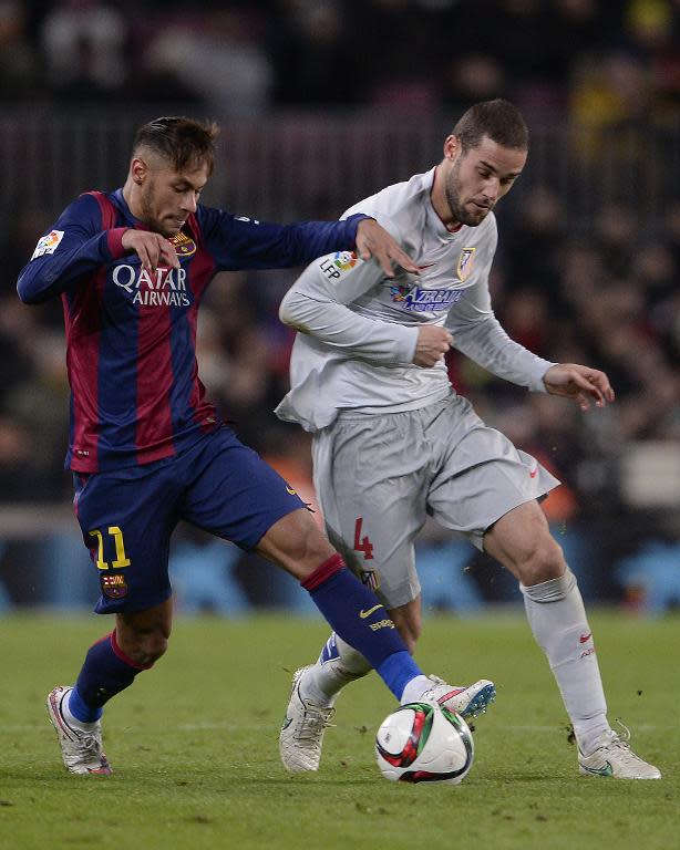 Barcelona's Brazilian forward Neymar da Silva Santos Junior (L) vies with Atletico Madrid's midfielder Mario Suarez during their Spanish Copa del Rey quarter final first leg football match in Barcelona on January 21, 2015