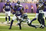 Minnesota Vikings running back Alexander Mattison (25) is tackled by Seattle Seahawks cornerback Tre Flowers (21) in the first half of an NFL football game in Minneapolis, Sunday, Sept. 26, 2021. (AP Photo/Bruce Kluckhohn)