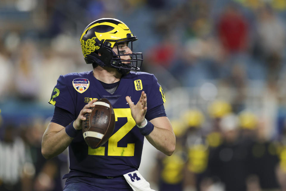 Dec 31, 2021; Miami Gardens, Florida, USA; Michigan Wolverines quarterback Cade McNamara (12) looks to throw against the Georgia Bulldogs in the third quarter during the Orange Bowl college football CFP national semifinal game at Hard Rock Stadium. Mandatory Credit: Sam Navarro-USA TODAY Sports