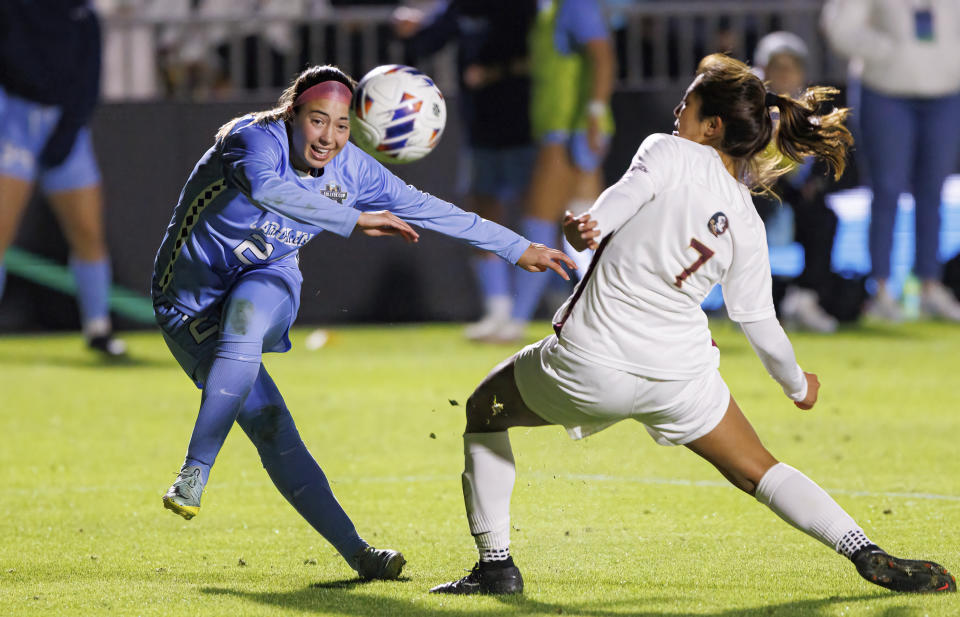 North Carolina's Talia Dellaperuta, left, attempts a shot past Florida State's Ryan Iwai (7) during the second half of an NCAA women's soccer tournament semifinal in Cary, N.C., Friday, Dec. 2, 2022. (AP Photo/Ben McKeown)