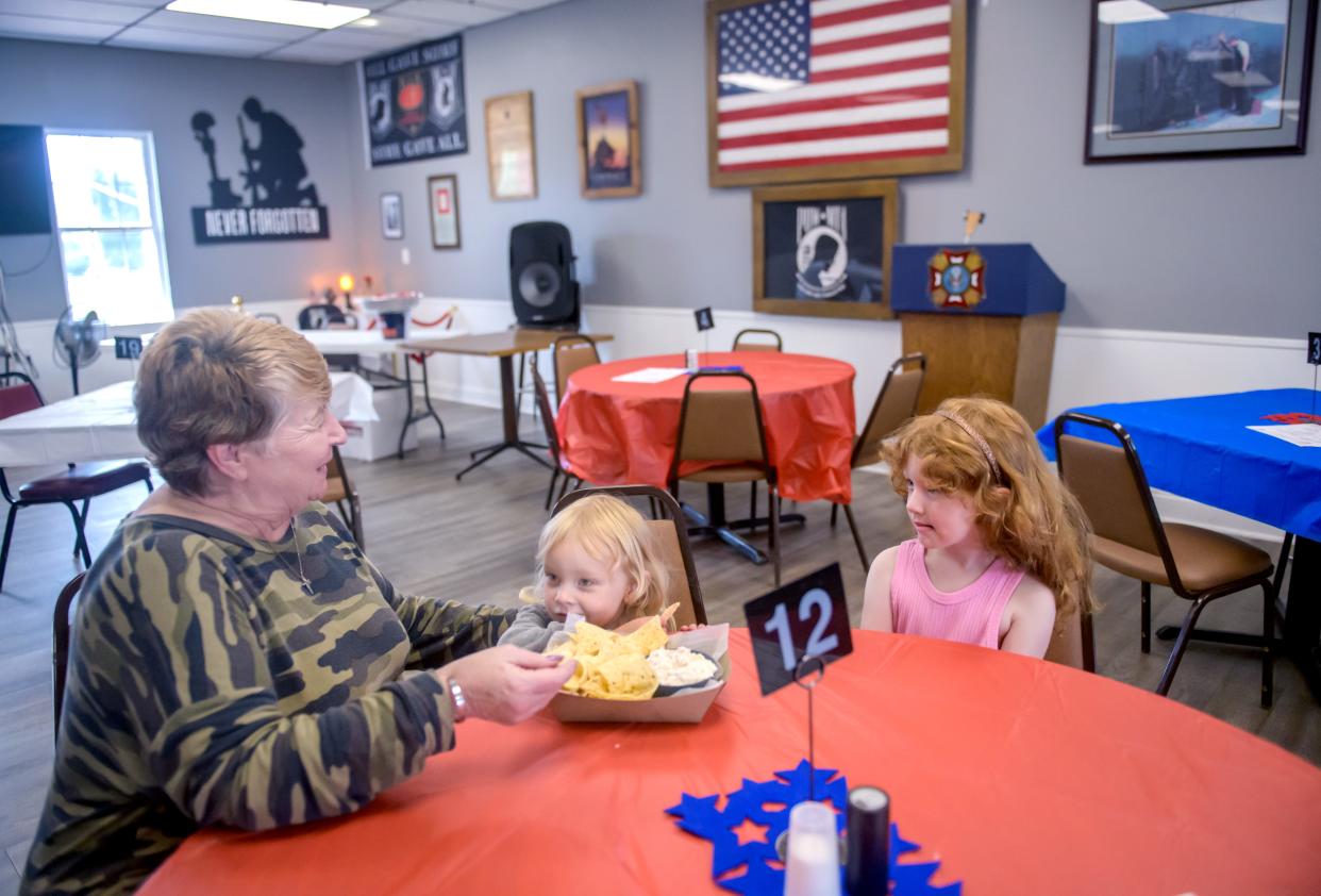 Cyndy Jefford, left, manager of the new Freedom Cafe, entertains two of her great-grandchildren, Scarlet, middle, 2, and Freya Fisher, 4, at VFW Post 9016 in Washington. Jefford started the cafe at the VFW Post to honor the many veterans in her family, including a disabled grandson who served in Afghanistan.