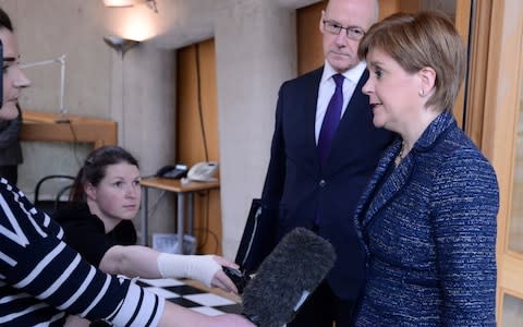 Scotland's First Minister Nicola Sturgeon faces the media on the way to First Minister's Questions in the Scottish Parliament, as it was reported that her predecessor Alex Salmond has been arrested and is due to appear in court - Credit: Getty Images