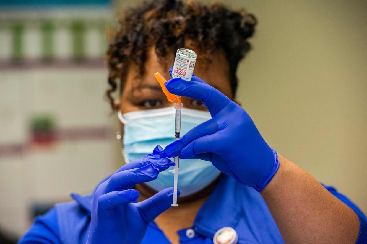 In this file photo, registered nurse Natalie O'Connor loads syringes with the Moderna COVID-19 vaccine at Hartford HealthCare at Home in Bloomfield, Connecticut on February 12, 2021, before heading out to see patients at their homes.