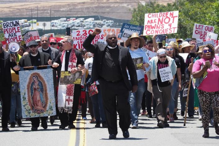 Pastor and activist Ben McBride, pictured leading protestors outside the Otay Mesa Detention Center, requested a prayer for "our immigrant relatives" (AFP Photo/Robyn Beck)