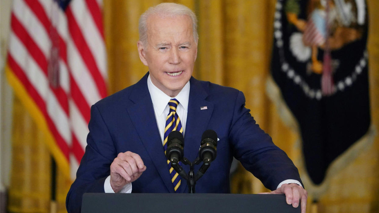 President Joe Biden stands at a podium during a news conference at the White House.