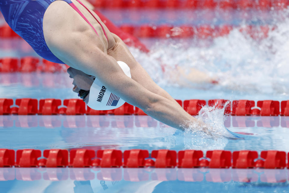 <p>USA's Erika Brown (L) competes to win against China's Wu Qingfeng in a swim-off for the women's 4x200m freestyle relay swimming event during the Tokyo 2020 Olympic Games at the Tokyo Aquatics Centre in Tokyo on July 28, 2021. (Photo by Odd ANDERSEN / AFP) (Photo by ODD ANDERSEN/AFP via Getty Images)</p> 