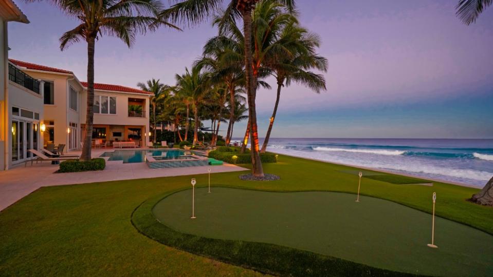 The ocean-facing backyard is an entertainer’s dream, complete with a pool and putting green. - Credit: Cliff Finley, Picture It Sold Photography