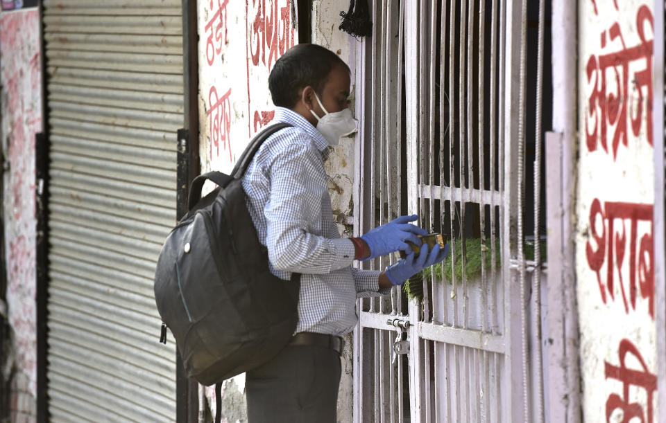 NOIDA, INDIA  MAY 6: A man buys alcohol from a liquor store during lockdown, on May 6, 2020 in Noida, India. (Photo by Virendra Singh Gosain/Hindustan Times via Getty Images)