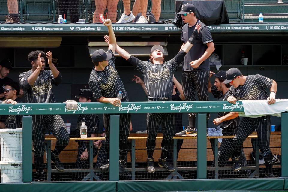 Vanderbilt players celebrate after a call at the plate was reversed and Vanderbilt was awarded a run during the eighth inning of an NCAA college baseball super regional game against East Carolina, Friday, June 11, 2021, in Nashville, Tenn. Vanderbilt won 2-0. (AP Photo/Mark Humphrey)