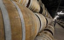 FILE PHOTO: Technician inspects oak barrels in a cellar where cognac is aged at the Remy Martin distillery in Cognac
