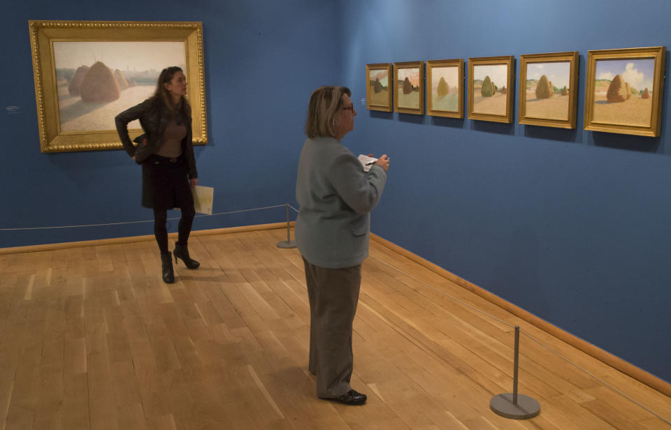 People look at the paintings of American painter John Leslie Beck 1860-1899, "Studies of a Autumn Day", 1891, during the exhibition "American Impressionism: A New Vision", at the Impressionist museum in Giverny, 70 kms (45 mls) north west of Paris, on Friday, March 28, 2014. A new exhibit at Normandy’s Impressionism Museum tells for the first time the little-known story of American Impressionism from where it all began _ at the picturesque water lily-filled Giverny gardens of Claude Monet that Americans colonized for three decades. (AP Photo/Michel Euler)