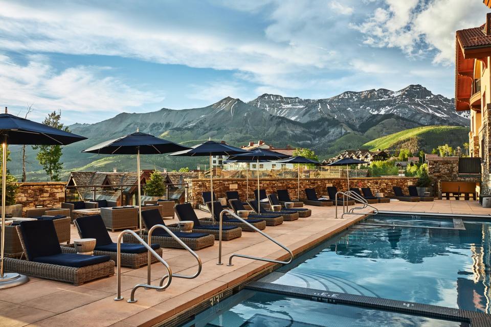 Summer view of the pool with mountains in the background at Madeline Hotel and Residences, Auberge Resorts Collection