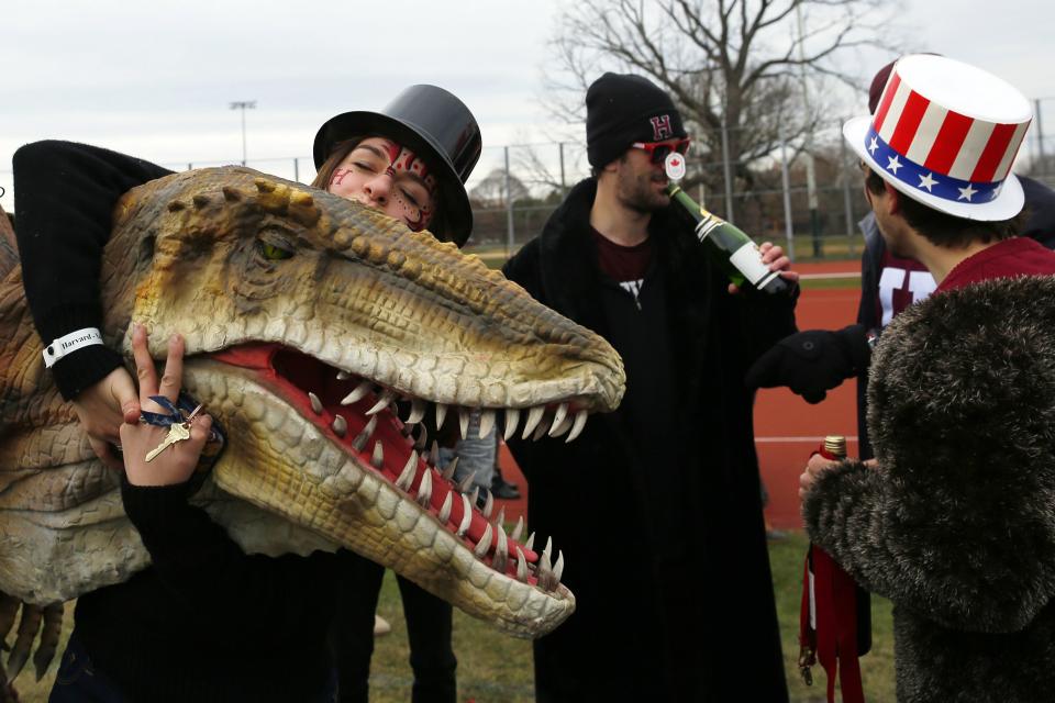 Harvard University football fans take part in a pre-game tailgate-style party outside the stadium before their football game against Yale University at Harvard in Cambridge, Massachusetts November 22, 2014. Known as "The Game," the first Harvard versus Yale football game was played in 1875, making it one of the oldest rivalries in college sports. REUTERS/Brian Snyder (UNITED STATES - Tags: EDUCATION SPORT FOOTBALL)