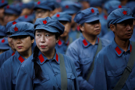 Participants dressed in replica red army uniforms stand in formation during a Communist team-building course extolling the spirit of the Long March, organised by the Revolutionary Tradition College, in the mountains outside Jinggangshan, Jiangxi province, China, September 14, 2017. REUTERS/Thomas Peter