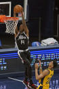 Los Angeles Clippers' Terance Mann (14) dunks against Indiana Pacers' Jeremy Lamb (26) during the second half of an NBA basketball game, Tuesday, April 13, 2021, in Indianapolis. (AP Photo/Darron Cummings)