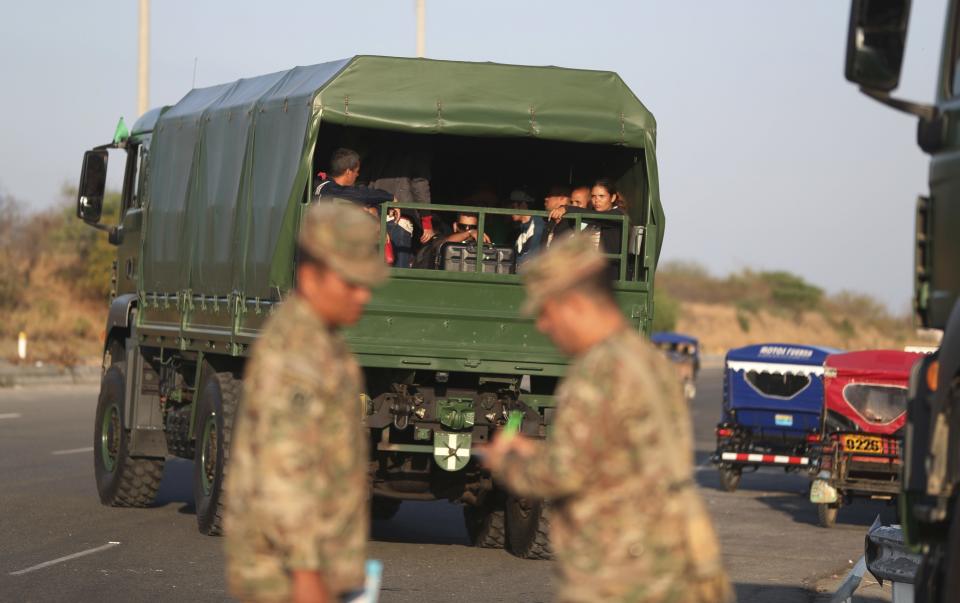 Venezuelan migrants are transported in Peruvian Army truck on the Pan-American Highway, after stricter entry requirements went into effect, in Tumbes, Peru, Saturday, June 15, 2019. With its relatively stable economy and flexible immigration laws, Peru has become a main destination for millions of Venezuelans escaping hyperinflation, medical shortages and political repression at home. (AP Photo/Martin Mejia)