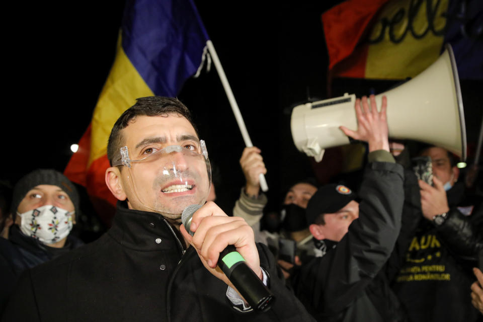 George Simion, one of the leaders of the Alliance for the Unity of Romanians or AUR, speaks to protesters after a deadly fire at a hospital treating COVID-19 patients in Bucharest, Romania, Saturday, Jan. 30, 2021. Hundreds marched during a protest organized by the AUR alliance demanding the resignation of several top officials, after a fire early Friday at a key hospital in Bucharest that also treats COVID-19 patients killed five people. (AP Photo/Vadim Ghirda)