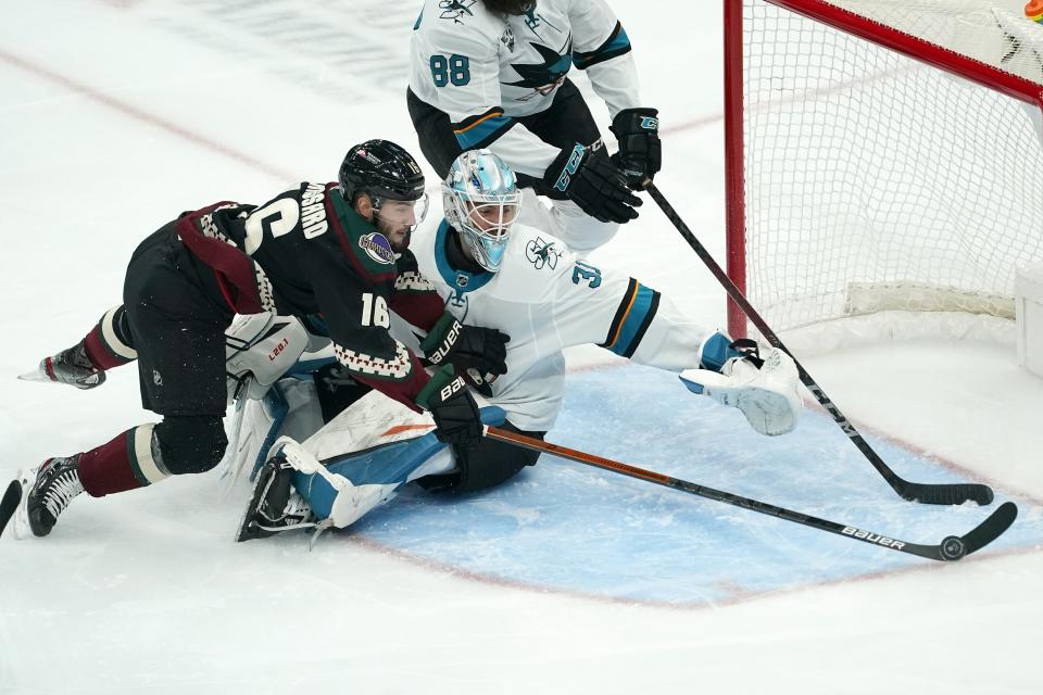 San Jose Sharks goaltender Martin Jones (31) stops a shot by Arizona Coyotes center Derick Brassard (16) during the first period of an NHL hockey game Saturday, Jan. 16, 2021, in Glendale, Ariz. (AP Photo/Ross D. Franklin)