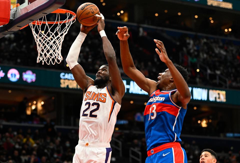 Feb 5, 2022; Washington, District of Columbia, USA; Phoenix Suns center Deandre Ayton (22) shoots as Washington Wizards center Thomas Bryant (13) defends  during the first half at Capital One Arena. Mandatory Credit: Brad Mills-USA TODAY Sports