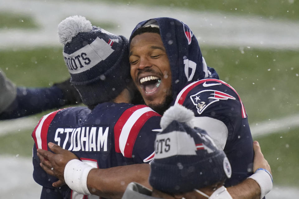 New England Patriots quarterbacks Jarrett Stidham, left, and Cam Newton embrace on the sideline at the end of an NFL football game against the New York Jets, Sunday, Jan. 3, 2021, in Foxborough, Mass. (AP Photo/Elise Amendola)
