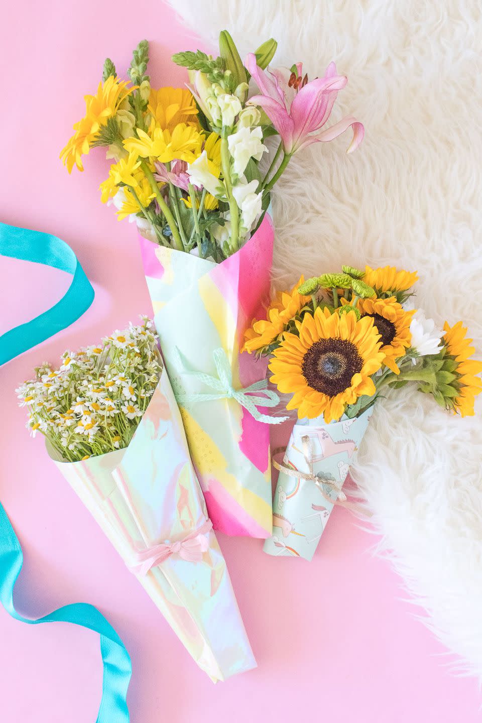 <p>Turn your garden's flowers into a bouquet fit for a queen by wrapping them in patterned paper. </p><p><em><a href="https://www.clubcrafted.com/2018/05/03/how-to-wrap-a-bouquet-of-flowers-wrapping-paper/" rel="nofollow noopener" target="_blank" data-ylk="slk:Get the tutorial at Club Crafted »;elm:context_link;itc:0;sec:content-canvas" class="link ">Get the tutorial at Club Crafted »</a></em> </p>